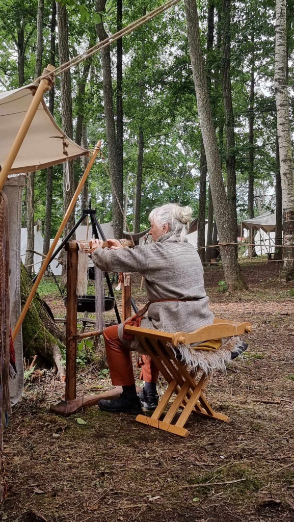 Bente P. Skogsaas beside the replica of the small weaving frame from Oseberg. The photograph was taken at the Borre Viking Market.