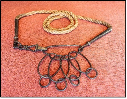 Most of the rattles do not have iron handles. Sixteen were found with a separate hook attached to the side of the rattle (on the right in the picture). Krydsby Kåresen suggests that the hook was attached to a wooden handle, and a leather or linden bast rope was then tied to it. The rope was used to secure the load. (Photo: Kjetil Kåresen)  